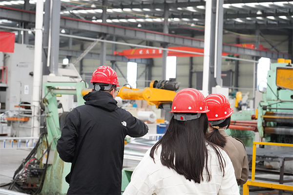 The safety officer is checking the machine for safety problems